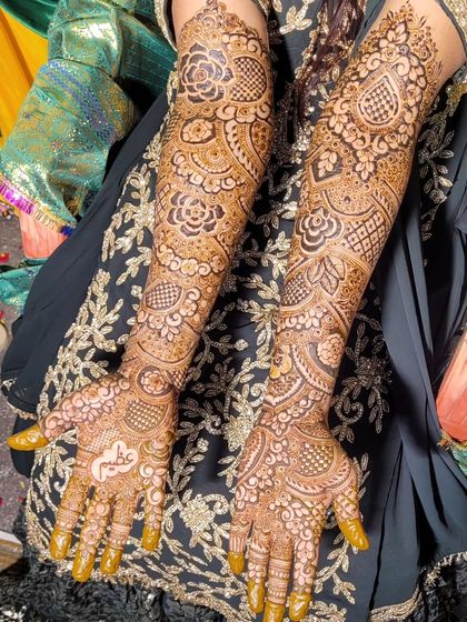 This is a beautiful example of a full bridal design that covers the arms from fingertips to elbow. The pattern is rich with florals, leaves, and shaded elements for a very full look.