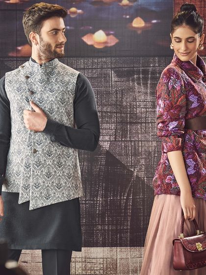 This ensemble features a grey patterned asymmetrical waistcoat over a dark kurta. It is a perfect example of our modern approach to layering in ethnic wear.