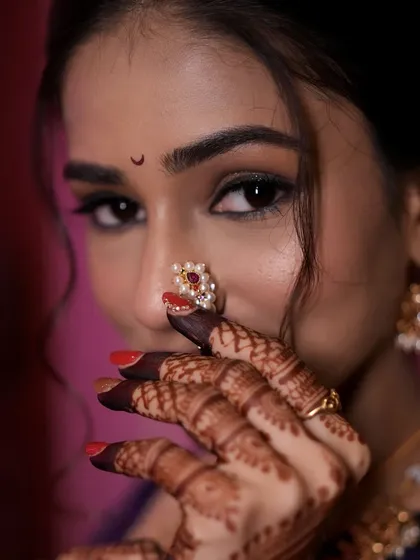 A close-up showcasing the bride's delicate nath and subtle eye makeup.