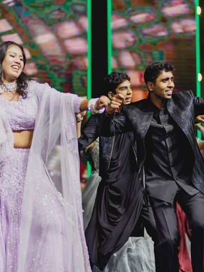 The bride and her brother join the friends' group dance for a fun and inclusive performance.