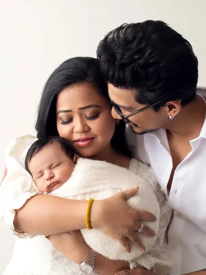 A loving family portrait of Bharti Singh and Haarsh Limbachiyaa with their newborn son. This image perfectly captures the joy of new parenthood.