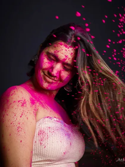 A candid moment from our Holi shoot. The flying pink powder and the model's happy expression perfectly capture the wild and joyful energy of the festival.