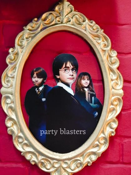 It's all in the details. This custom-framed picture of Harry, Ron, and Hermione adds an authentic touch to our Harry Potter themed events, making the fantasy feel real.