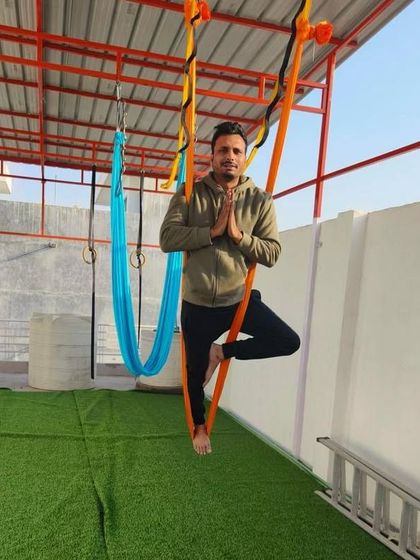 A student practices the Tree Pose in the air. It's a great balance challenge.