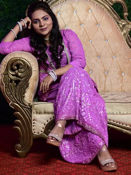 I designed this purple sharara suit with intricate Lucknowi work for a client. The detailed embroidery and rich color make it a perfect outfit for festivals or family functions.