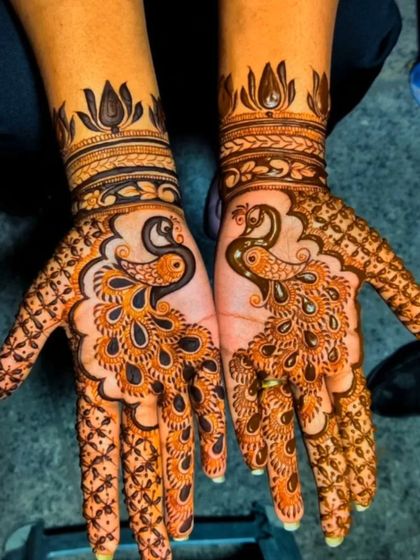 A classic peacock design, with the feathers flowing beautifully down the fingers.