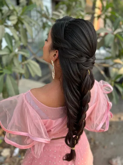 A side view of the mermaid braid, showing how the hair is swept back from the face to keep the look clean and elegant.