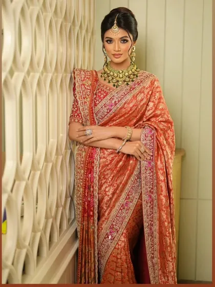 The full-length pose shows how the saree's pallu is styled with a Banarasi Rai Bandej dupatta for a truly unique bridal look.