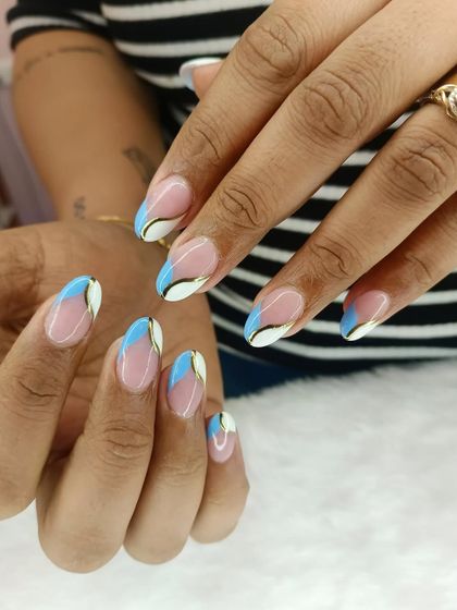 A cool and abstract take on the French manicure. This design uses blocks of white and sky blue, separated by a fine gold line, to create a modern and graphic tip.