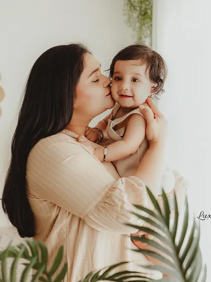 A mother's loving kiss on her baby's cheek. We use a soft, cinematic editing style to enhance the warmth and emotion of the moment.