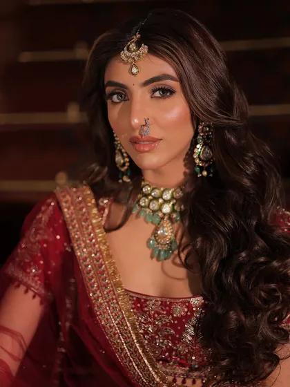 This portrait captures a sense of opulence and royalty. The styling focuses on the rich textures of the Kajal Rajput outfit and the intricate details of the jewellery.
