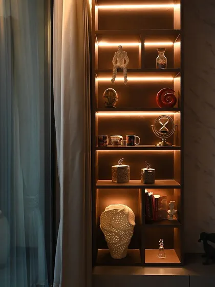 Backlighting on this display shelf turns everyday objects into a curated collection. It's a simple but effective way to add warmth and personality to a room.