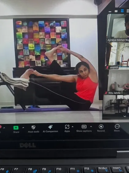 A student using a chair for support during our online hip opening class. The focus is always on safe and effective practice, even through a screen.