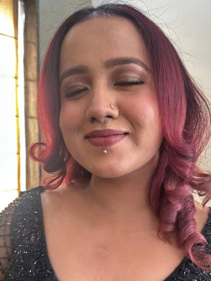 Eyes closed to show the blending of the brown smokey eyeshadow. It's a warm and flattering look for many skin tones.