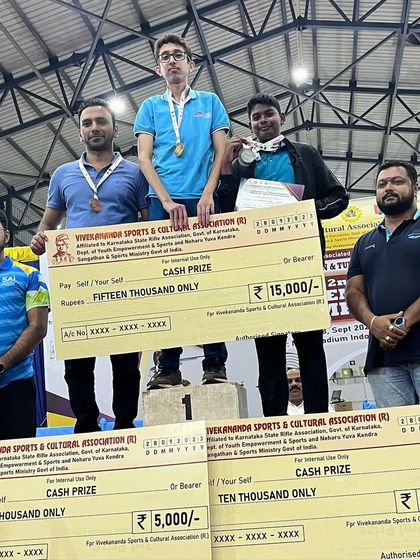 Satvik and Jonathan on the podium with their cash prizes after dominating the Air Pistol men's events at the Tumkur competition.
