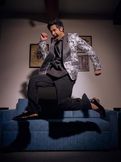 Not just an outfit, but a roar in style. This dynamic shot captures the energy of our black and white floral blazer from the Sukoon collection, a head-turner for any wedding function.