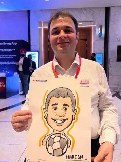 Caricatures are a big hit at corporate events. This attendee from a convention at Jio World holds his portrait, personalized with a football to reflect his interests.