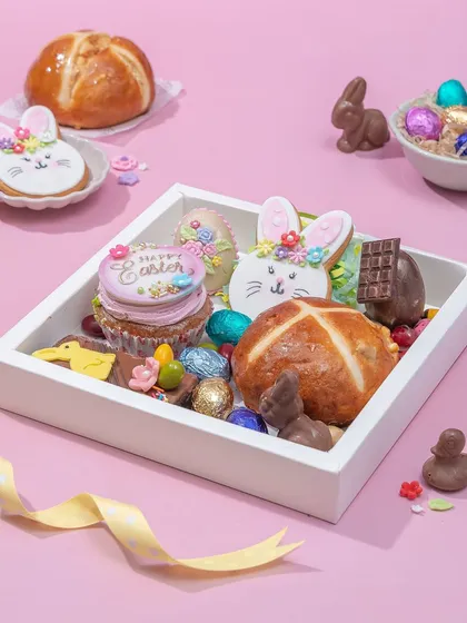 The Easter Treat Box, a curated selection of my bestsellers including hot cross buns, decorated cookies, a mini piñata egg, and chocolate bunnies. It's a perfect sampler of my Easter collection.