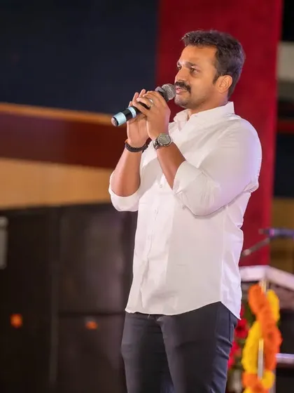 Capturing speakers and performers on stage is a core part of our event coverage. This photo shows a clean, professional shot of a guest addressing the audience during the audio launch.