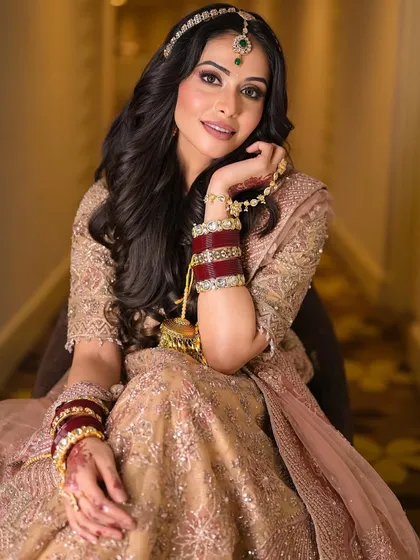 A playful and happy moment. The makeup looks just as beautiful when she smiles, proving that regal looks can also be fun and modern.