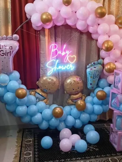 Here is a popular gender reveal baby shower theme I designed. It features a circular balloon arch with both pink and blue balloons, a "Baby Shower" neon sign, and matching B-A-B-Y blocks, creating a fun and suspenseful atmosphere for the parents-to-be.