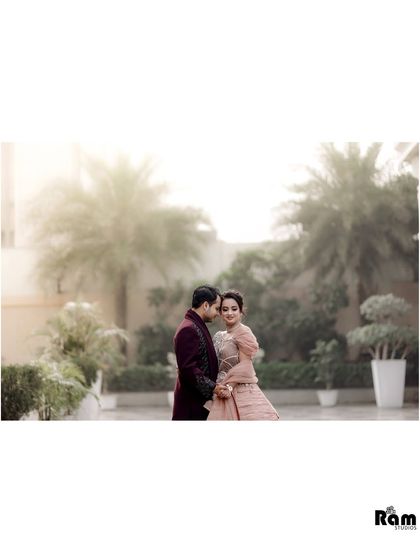 A soft and dreamy portrait of the couple in a garden. The foggy, bright background creates an ethereal atmosphere, focusing on their quiet and intimate connection.