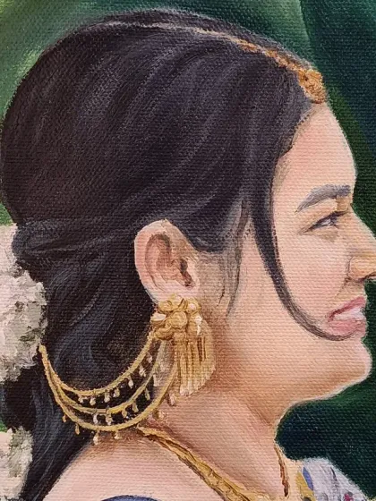 Close-up of the bride's face, showing her beautiful traditional jewelry and flowers in her hair.