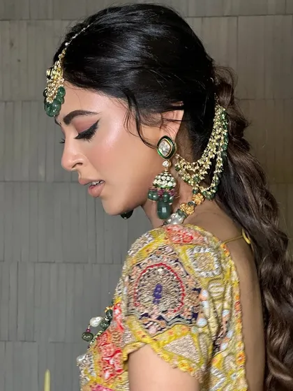 A side profile of this royal, traditional look, highlighting the perfectly executed winged eyeliner.