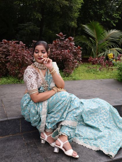 A seated pose showing the comfortable fit and elegant drape of the readymade Nauvari.