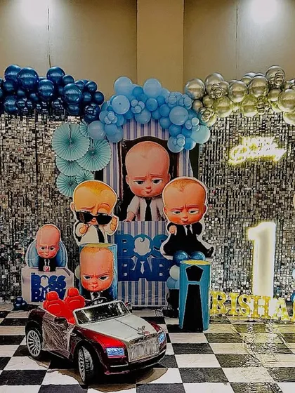 Here is a full view of one of my popular Boss Baby themed decorations. The setup includes a wide shimmer backdrop, a complete set of character cutouts, themed balloon columns, and a checkered floor to match the theme's style.