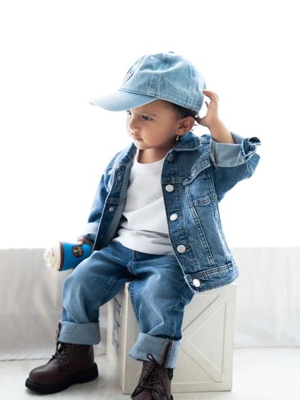 This toddler has so much swag. A stylish portrait session capturing a little boy's cool and confident personality in a full denim outfit.