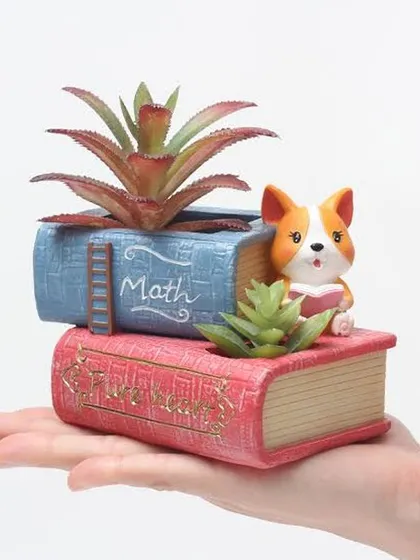 This unique resin planter is designed to look like a stack of books with a corgi reading alongside. It has two separate planting sections, making it a fun and functional piece for any book lover.