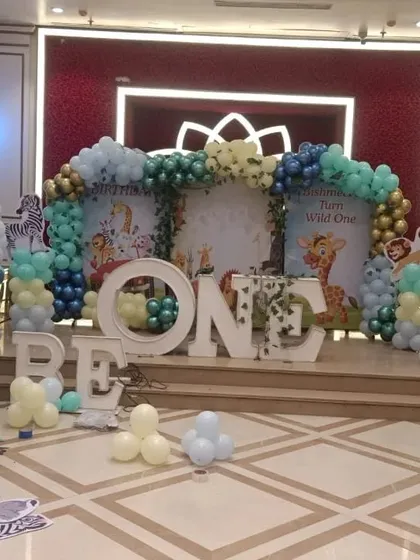 Here's a behind-the-scenes look as my team and I were preparing a "Wild One" jungle theme for a first birthday. You can see the backdrop panels and balloon structures coming together.