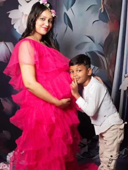 A fun and heartwarming maternity photo where the older brother-to-be shares a secret with the baby bump. I love capturing these family moments.