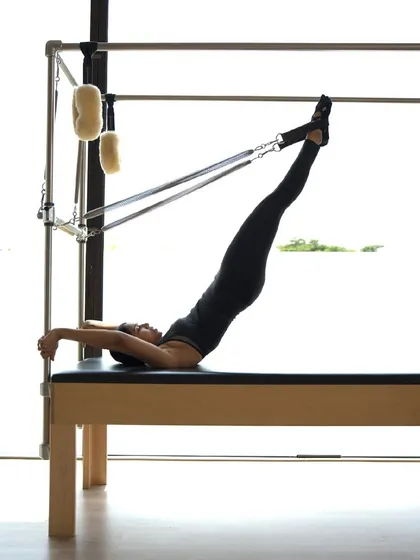This is the beauty of Classical Pilates in motion. Here, I am demonstrating an advanced exercise on the Cadillac, a testament to the strength, control, and flexibility that consistent practice develops over time.