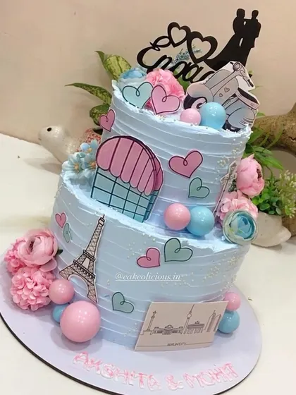 This thoughtful two-tier engagement cake tells the couple's story, depicting their journey of togetherness across Paris and Berlin. It's decorated with edible prints of the Eiffel Tower, hearts, and a scooter for a truly personal touch.