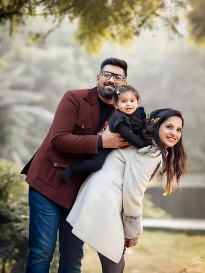 A playful and loving family portrait taken outdoors. We aim to capture the natural interactions and happiness that define your family.
