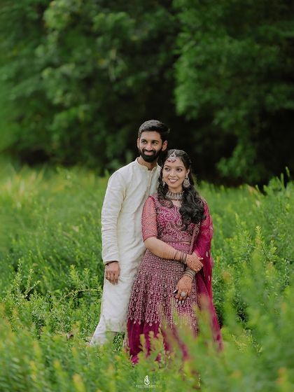 A classic portrait amidst tall green plants. The framing of the foliage adds depth and texture to the photograph.