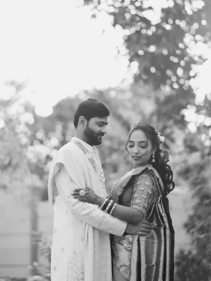 A soft and romantic black and white portrait. The couple shares a quiet moment, creating a feeling of timeless love and togetherness.