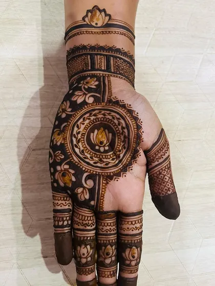 Another one of my favorite lotus-themed designs. The dark-filled areas create a beautiful contrast, making the central mandala and wrist band details pop.
