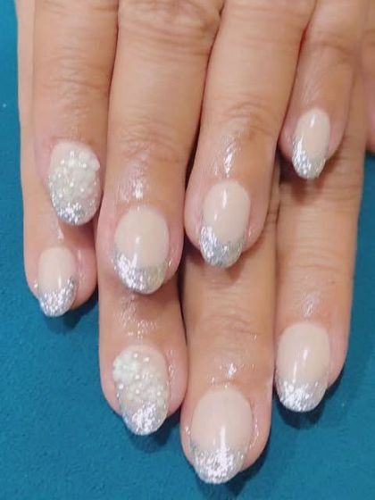 A simple way to add some sparkle to a classic look. This is a French manicure with silver glitter tips instead of the traditional white.
