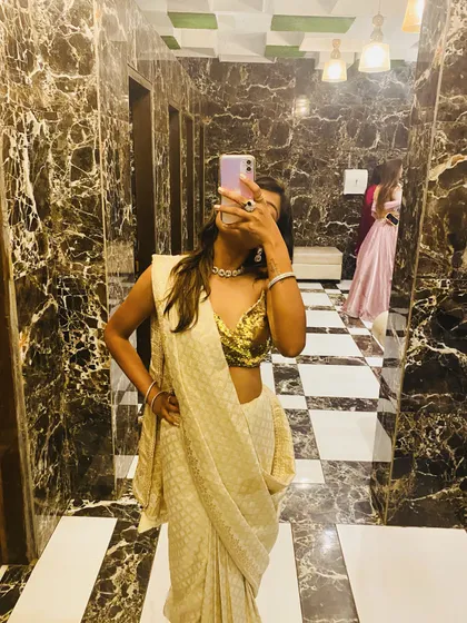 A mirror selfie capturing the details of my self-made saree and sequin blouse. I focus on creating outfits that are not only stylish but also make you feel amazing.