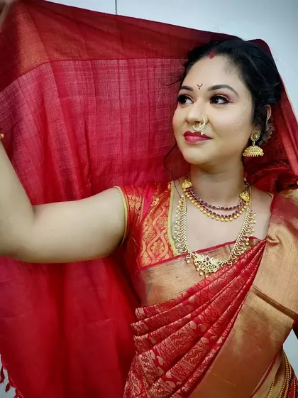 Another angle of the traditional South Indian bride, showcasing the draping of the silk saree and how the makeup enhances the richness of the fabric and gold jewelry.