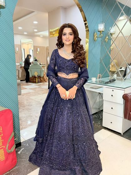 A full view of this engagement bride's stunning navy blue lehenga. The soft curls and flawless makeup complete this elegant and regal look.