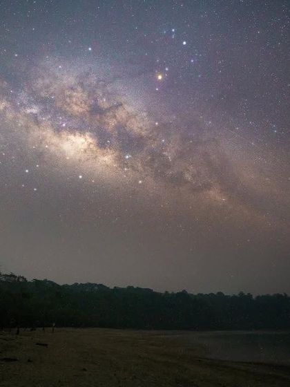 A clear view of the Milky Way, a barred spiral galaxy containing our solar system. This shot from a dark location highlights the structure of the galactic disk and its central bulge.