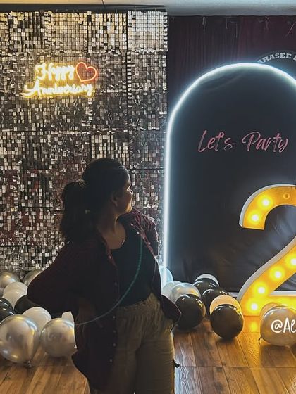 A guest enjoying the photo opportunity in front of our unique dual backdrop, a perfect spot for capturing memories.
