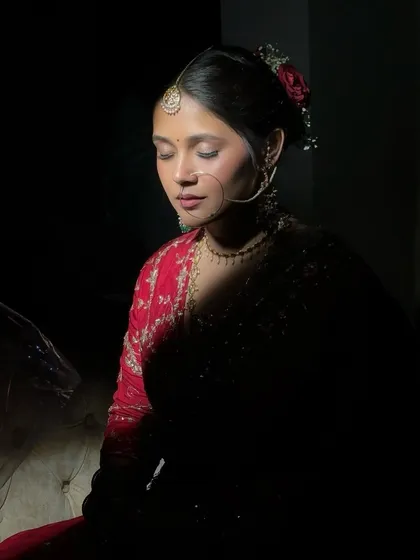 For the bride who believes less is more, a minimalist look can be incredibly powerful. This artistic shot captures a stunning bride in red, where the focus is on her natural beauty, enhanced with a clean, elegant makeup application.