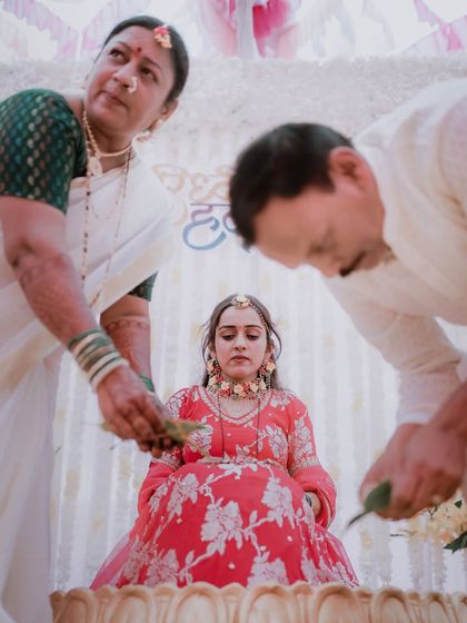 A traditional moment from a Haldi ceremony, where the bride receives blessings from her parents.