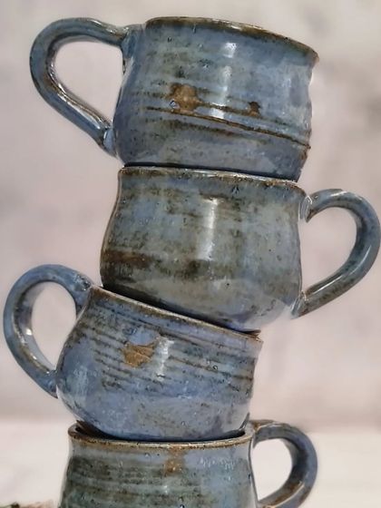 A stack of my blue glazed espresso cups. Each one is handmade, so they have slight variations that make them unique.