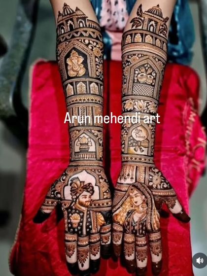 A classic portrait mehendi with the bride and groom on the palms and Ganesha on the forearm for blessings.